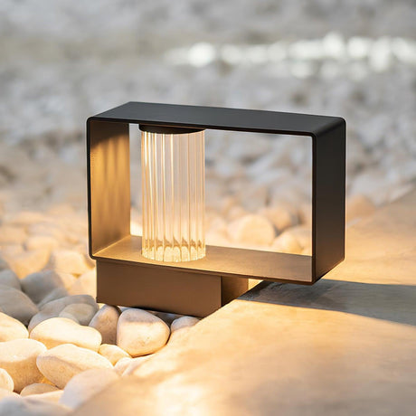 The low wide body lit on white pebbles beside a concrete terrace