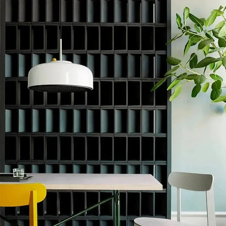 White honeycomb pendant above a table in front of a dark slatted wall
