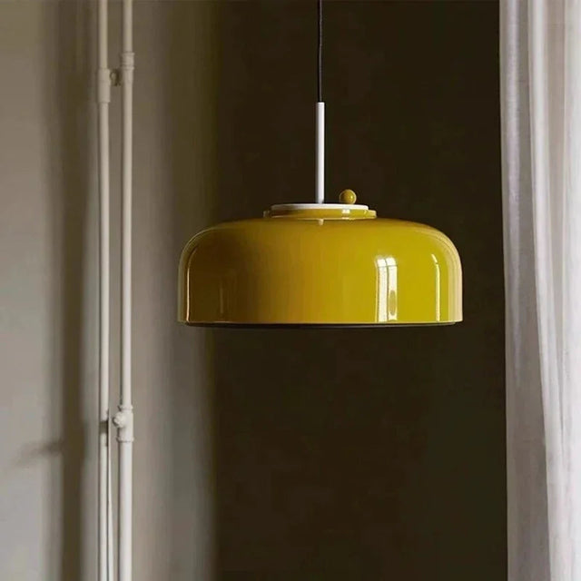 Modern pendant lamp in glossy yellow with a honeycomb mesh face, lit in a room