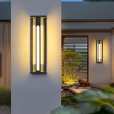 The light on a render wall with a lit garden and a low chair beyond it