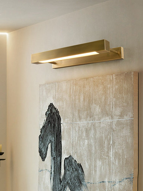 Brass bar lit over a wide textured canvas on a pale wall in a quiet room