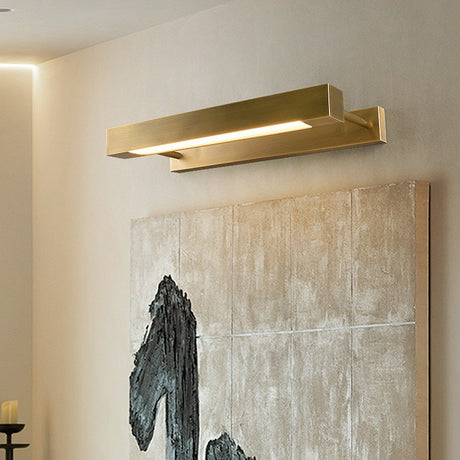 Brass bar lit above a large textured artwork on a pale plaster wall