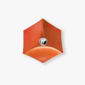 Orange folded shade wall light with a silver tipped bulb at its center