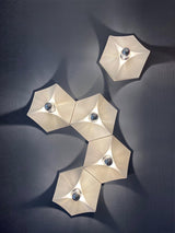 Several white lights grouped in a winding line on a dark wall
