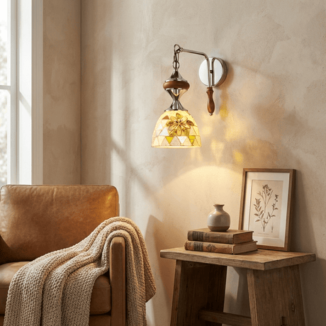 The sconce lit above a side table and a leather armchair with a knit throw