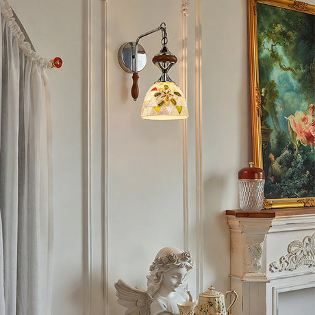 The shell mosaic version beside a painting and a white sculpture on a mantel