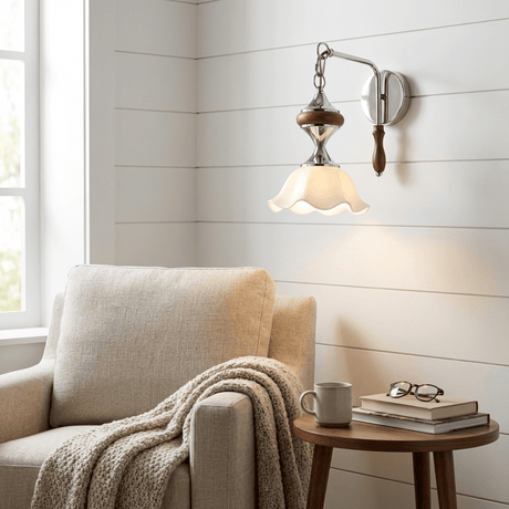 The white ruffled shade version lit above an armchair and a side table