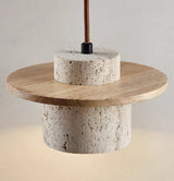 Travertine chandelier installed above dining table
