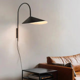 Wall sconce highlighting artwork on wall