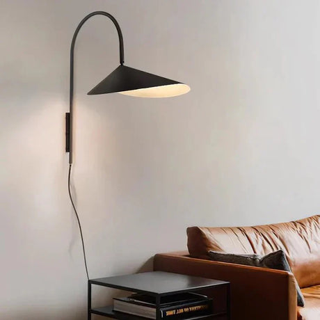 Wall sconce highlighting artwork on wall