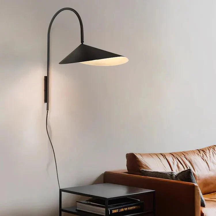 Wall sconce highlighting artwork on wall