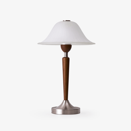 Nightstand table lamp with a frosted glass bell shade on a walnut stem, plain ground