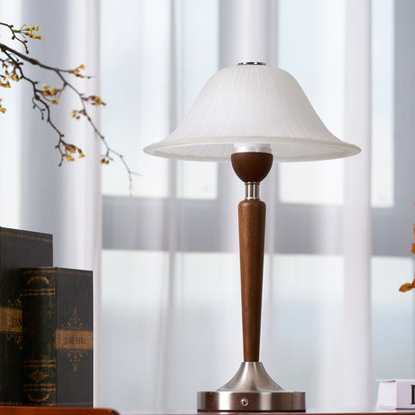 Nightstand table lamp lit on a chest in front of a bright window