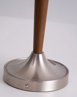Close view of the brushed nickel foot and the touch point on its edge