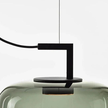 Close view of the black iron arm entering the top of the glass shade