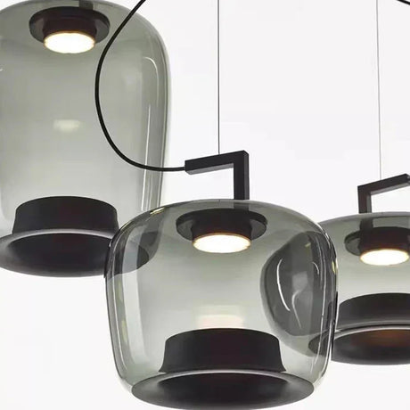 Cluster of tinted glass shades seen from below in a dark room