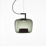 Single emerald green glass shade on a black arm against white