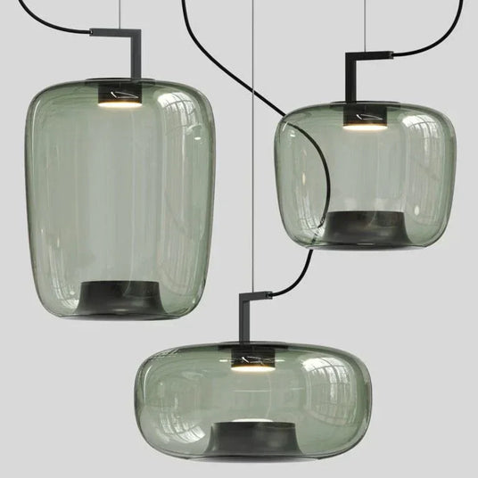 Three green glass shades at different heights above a pale floor