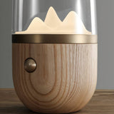 Close view of the wood base, the brass ring and the push button on the side