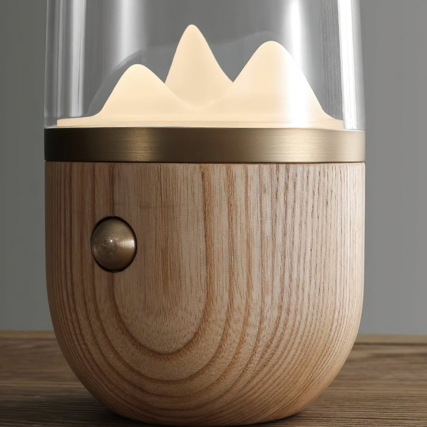 Close view of the wood base, the brass ring and the push button on the side