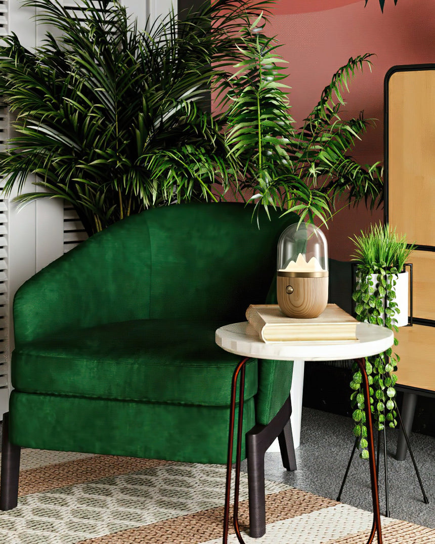 Nursery table lamp lit on a marble table beside a green armchair