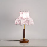 Pink blossom shade lamp lit, the panels glowing softly