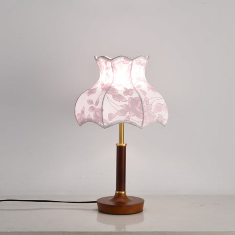 Pink blossom shade lamp lit, the panels glowing softly