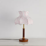Pink blossom shade lamp unlit against a plain pale ground