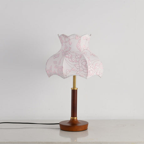 Pink blossom shade lamp unlit against a plain pale ground
