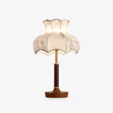 Table lamp with a scalloped blossom shade printed in gray on white