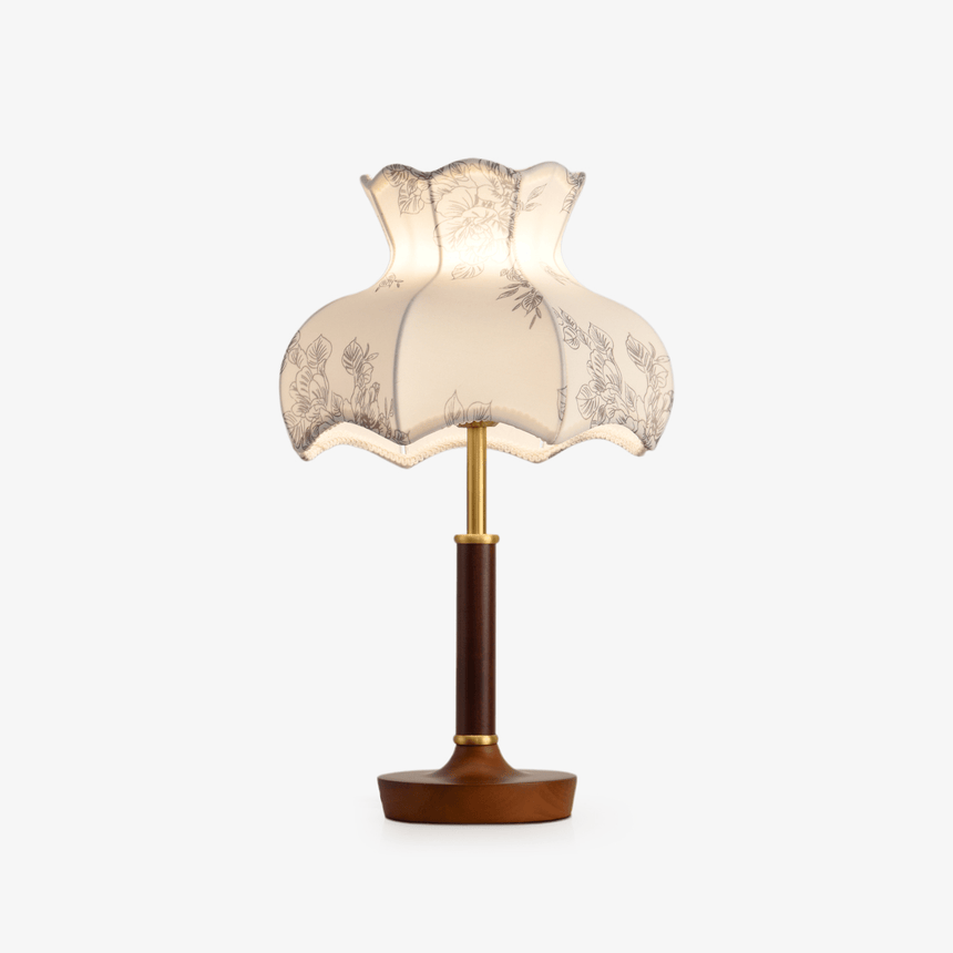 Table lamp with a scalloped blossom shade printed in gray on white