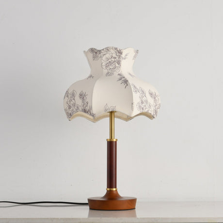 Close view of the scalloped blossom shade and the brass stem below