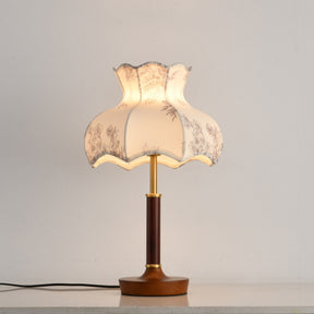White blossom shade lamp on a plain ground, the wood base below