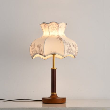 White blossom shade lamp on a plain ground, the wood base below