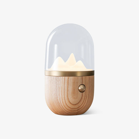 Nursery table lamp in light wood seen from the front against a plain ground