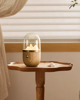 Nursery table lamp lit on a small wooden side table by a window