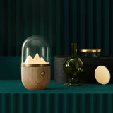 Nursery table lamp lit against a dark green fluted background with vases