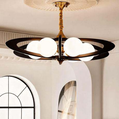 The rings lit beside an arched window in a plain plaster room