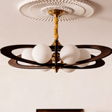 White opal globes lit close, the dark rings crossing behind them