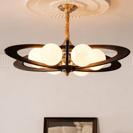 The fitting lit warm, the rings dark against a pale plaster ceiling