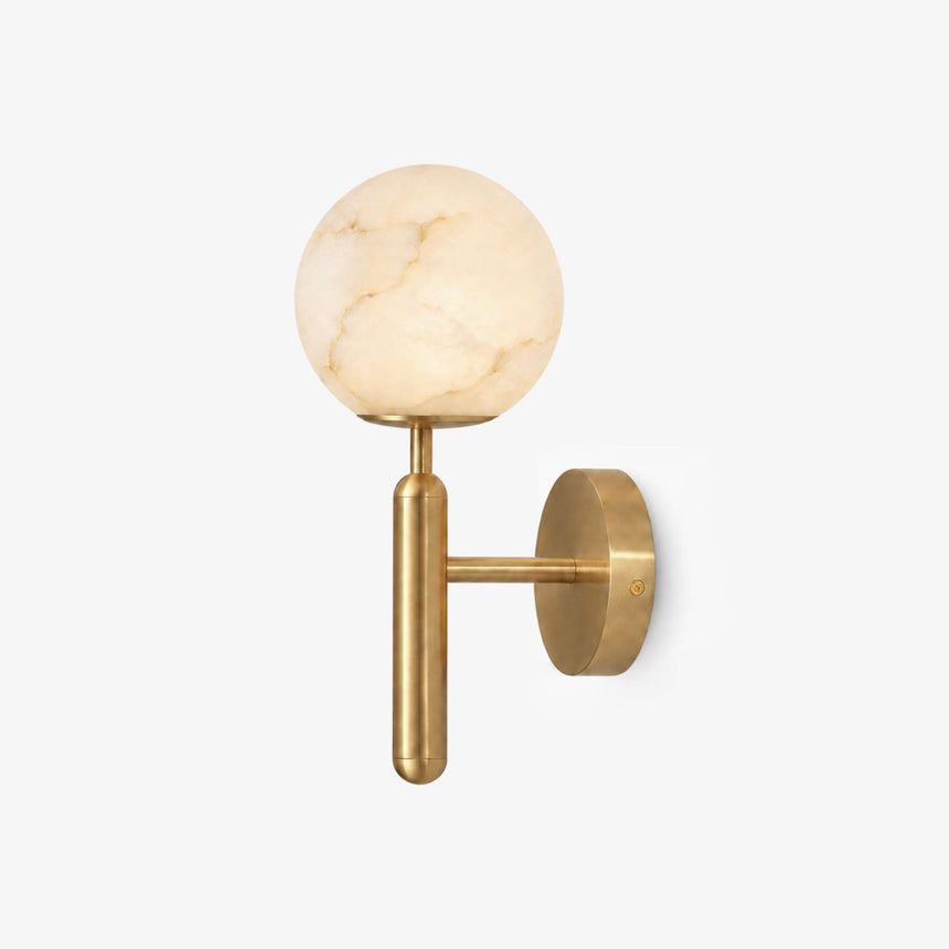 Carved stone globe on a slim gold T shaped stem with a round wall plate