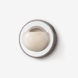 Round wall light with an alabaster half bowl set in a mirrored ring with a beaded rim
