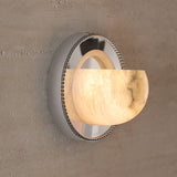 The orbit light lit on a textured plaster wall, the alabaster glowing