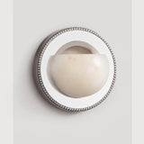 The orbit light on a pale background, showing the beaded rim