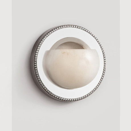 The orbit light on a pale background, showing the beaded rim