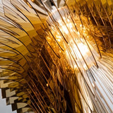 The amber acrylic layers lit close, each blade catching light along its edge