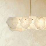A bar of overlapping stone petals seen straight on, lit