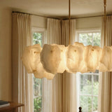 A lit petal bar in front of a window with curtains and a chair