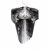 The same flowing form in black acrylic, layers fanning out around a lit core