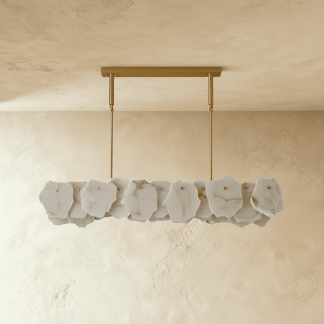 A linear bar of gray stone petals below a brass ceiling plate